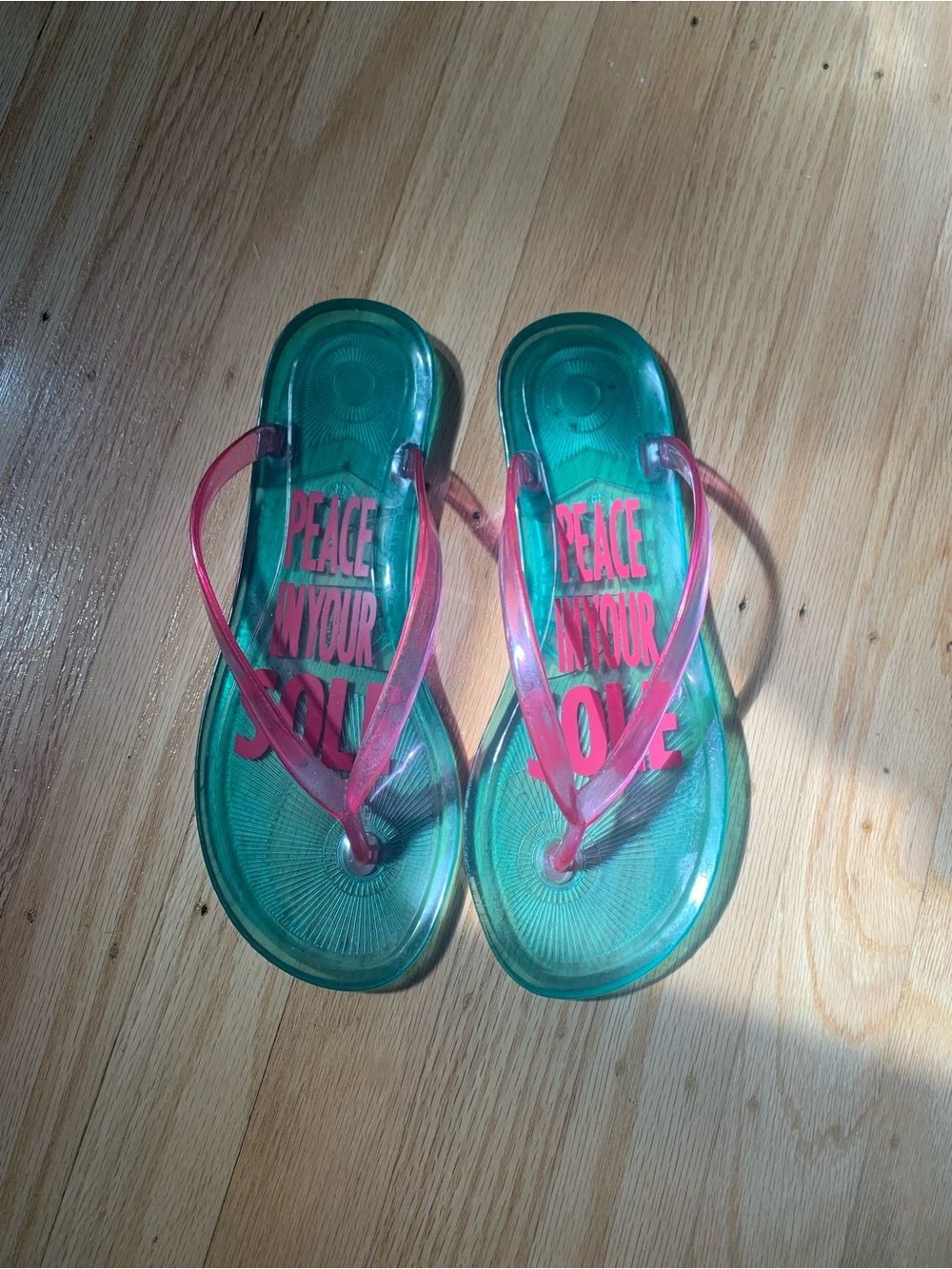 Pink and blue flip flops with the words 'PEACE IN YOUR SOUL'
